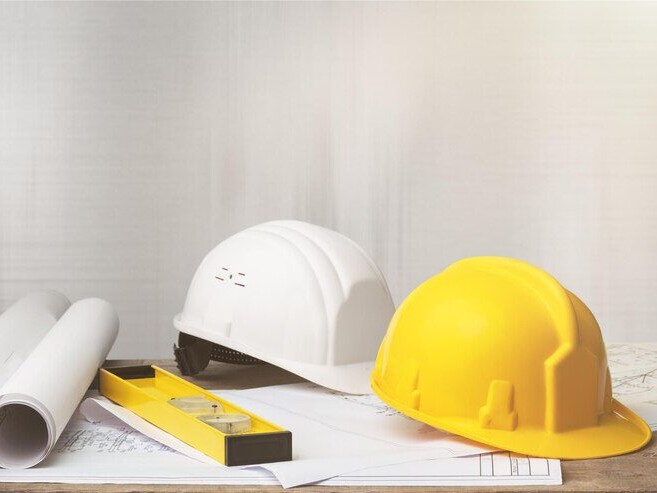 blueprint with level and hardhats on it