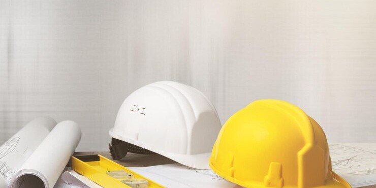 blueprint with level and hardhats on it