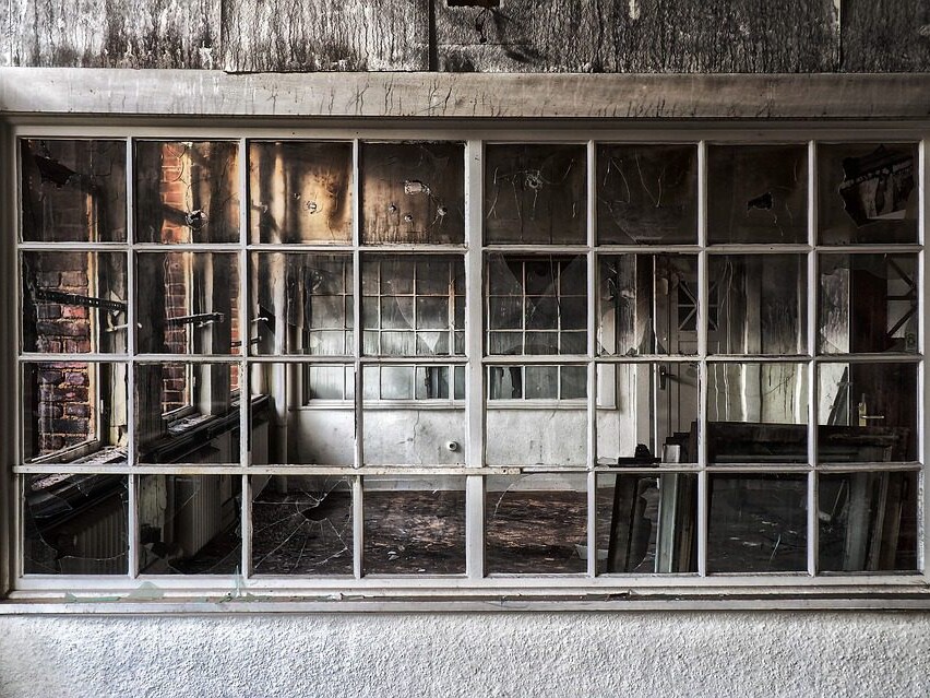 view of fire damaged house through an exterior window