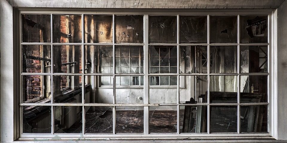 view of fire damaged house through an exterior window