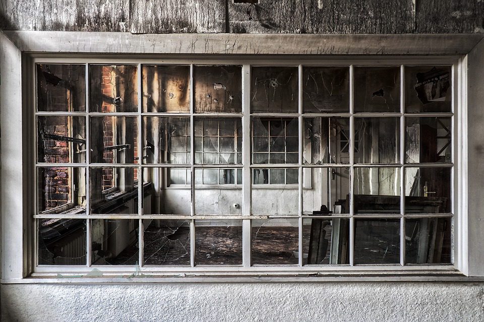 view of fire damaged house through an exterior window