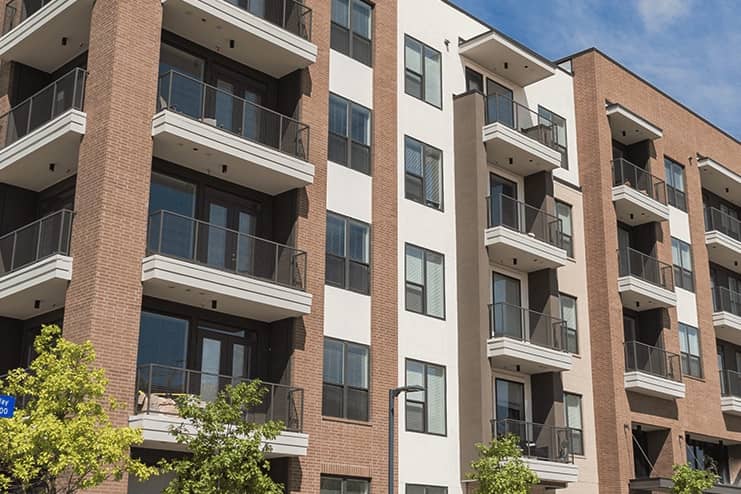exterior of apartment building with porches and windows