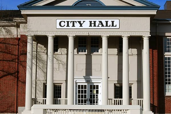 brick building with columns with sign