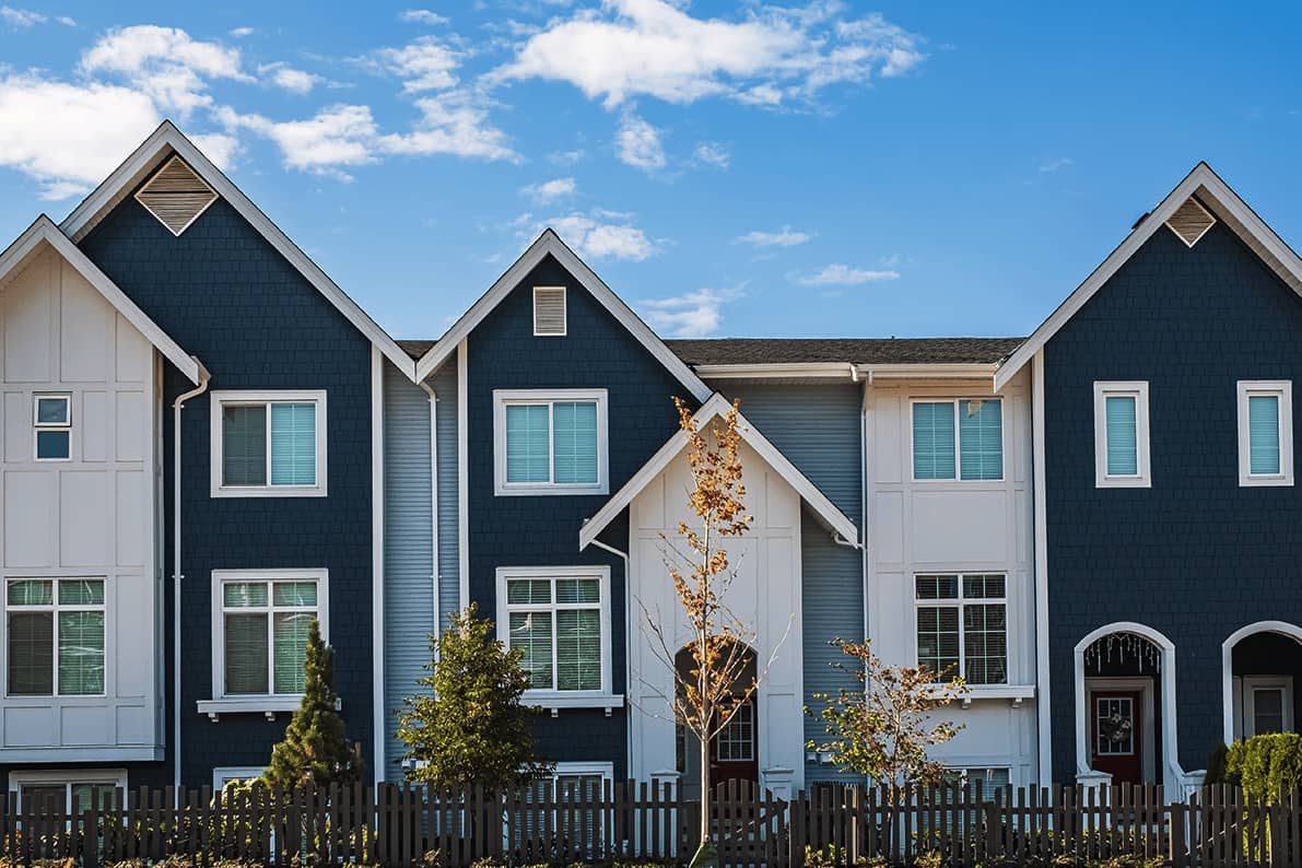 modern blue and white apartment building on a sunny day