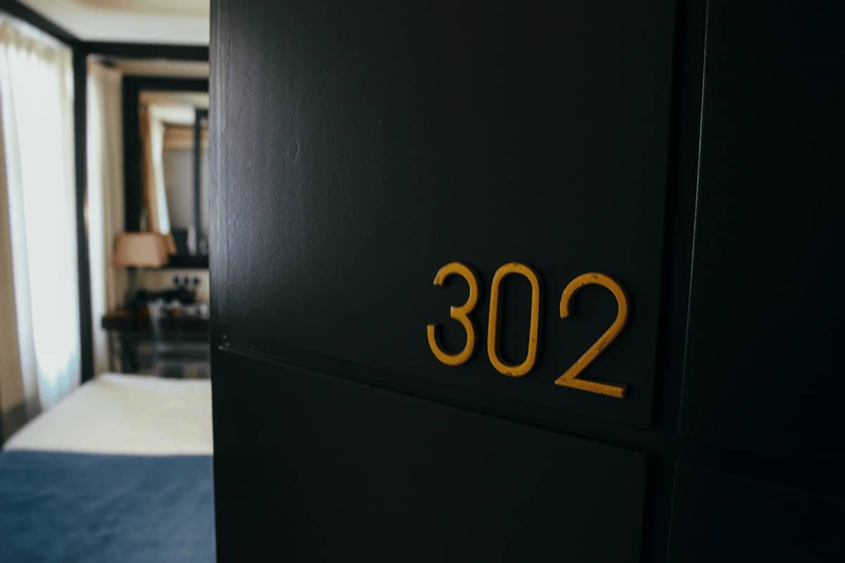 number 302 on an open door showing into a hotel room